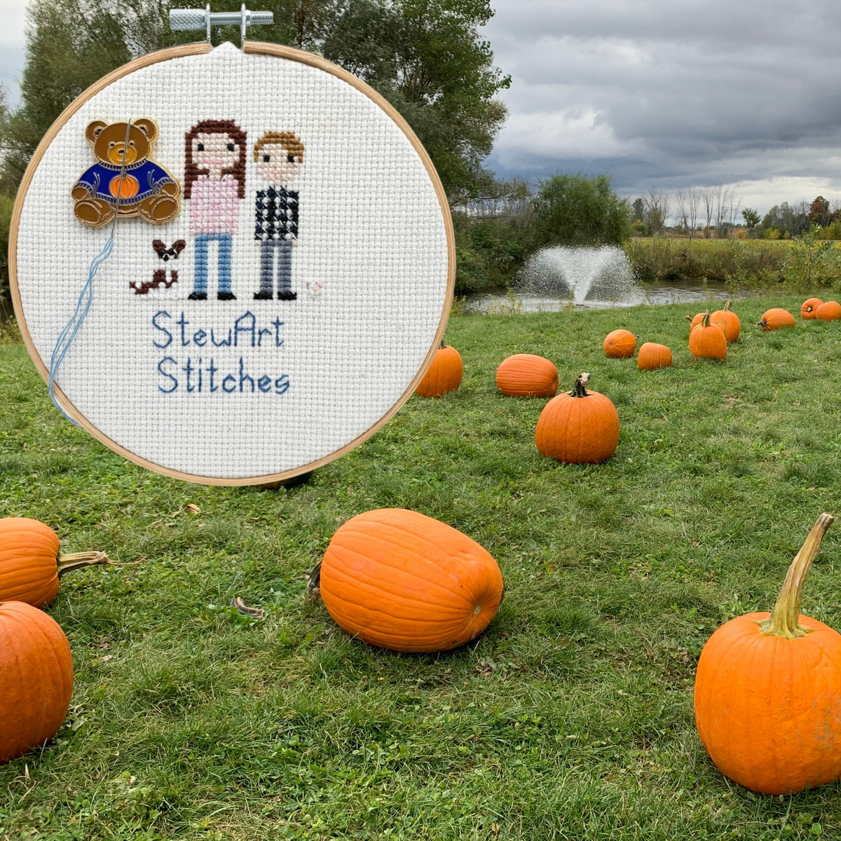 Teddy bear enamel needle minder wearing a blue sweater with a pumpkin, magnetic needle holder for cross stitch, needlepoint, embroidery, quilting, sewing and other stitching projects.