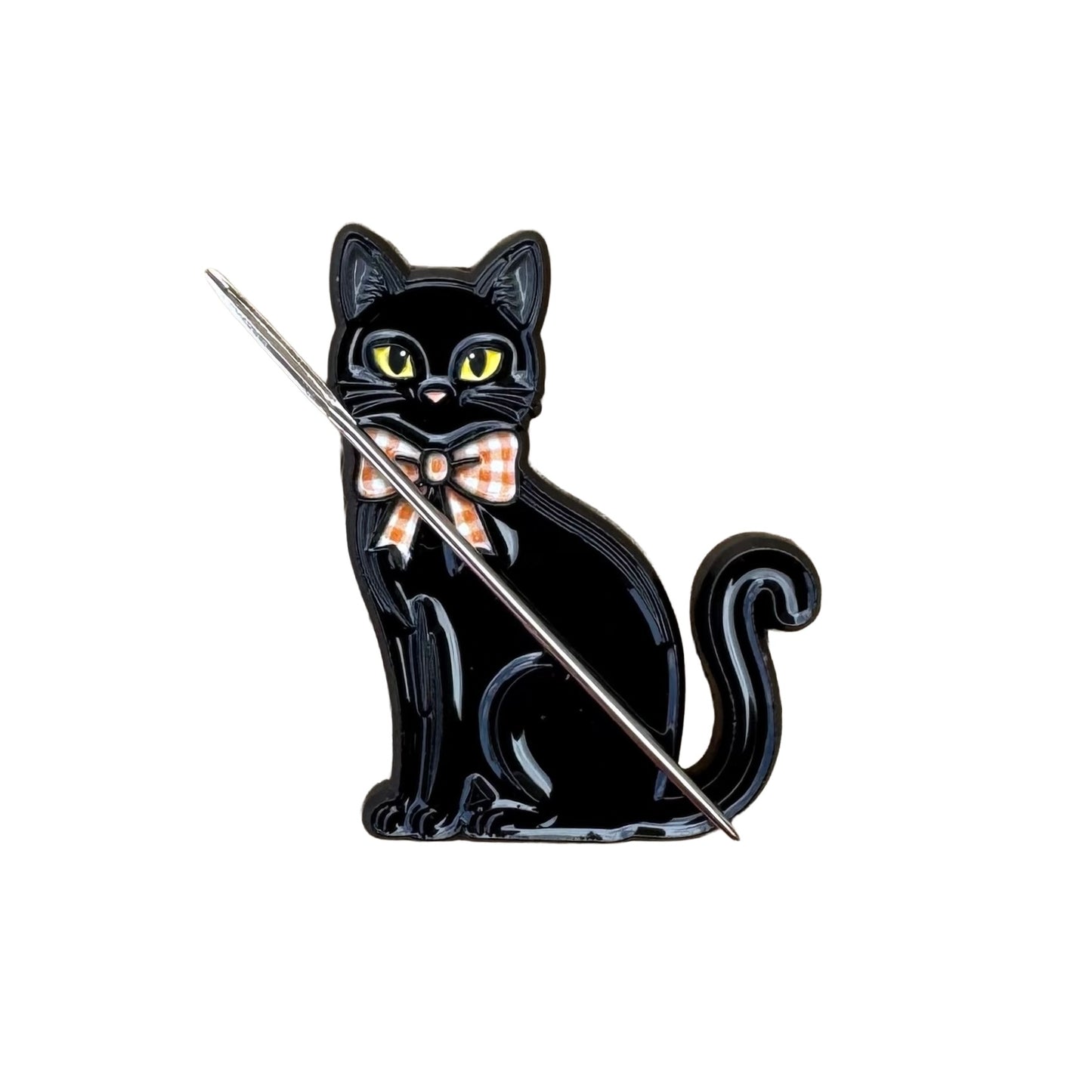 Close up of black cat  enamel needle minder with hard enamel finish and metal edging.
