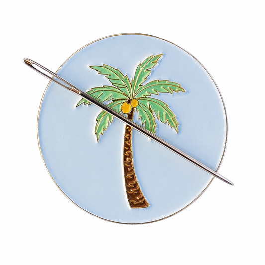 Close up of palm tree enamel needle minder with hard enamel finish and metal edging.