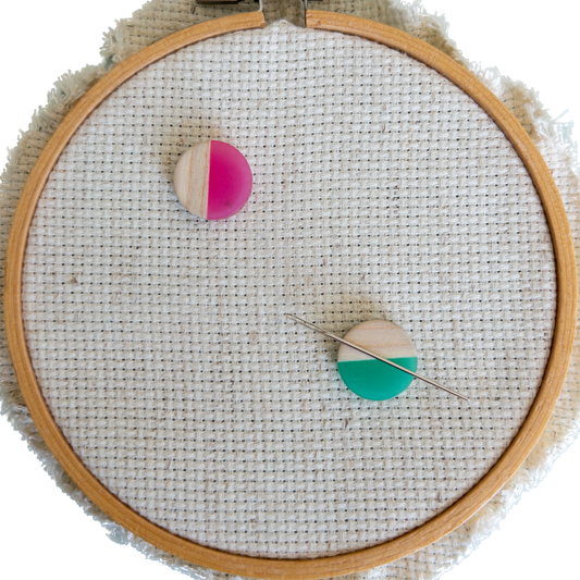 Set of 2 circle shaped magnetic needle minders with pink and green resin and natural wood – perfect for cross stitch, embroidery, needlepoint, quilting, and hand sewing. A unique and functional needle holder for stitchers and crafters.