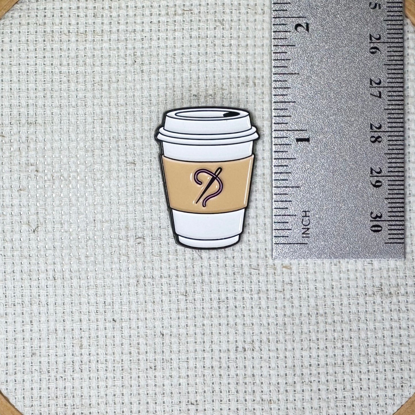 Coffee cup with needle and thread on the sleeve needle minder with strong magnet for stitching.