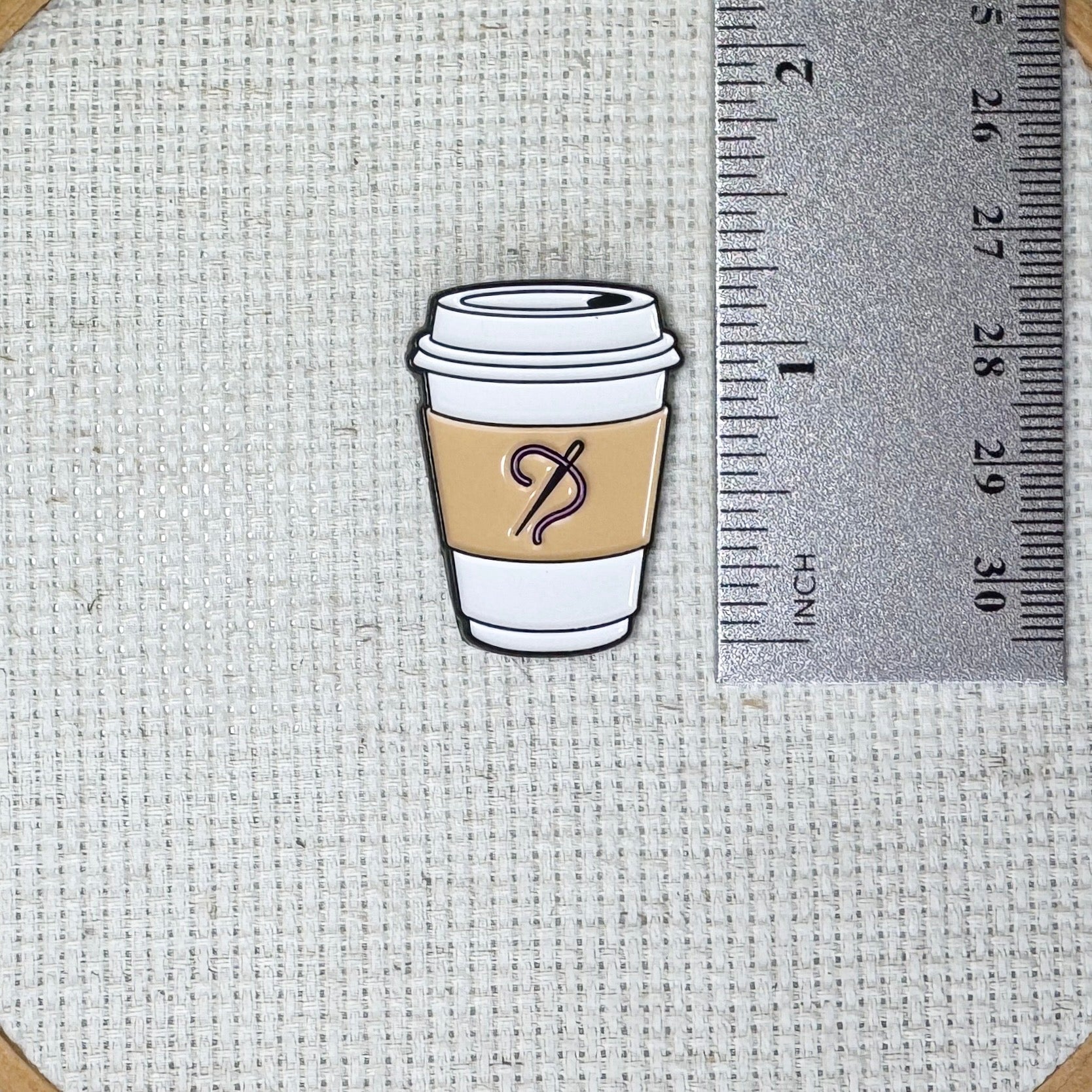 Coffee cup with needle and thread on the sleeve needle minder with strong magnet for stitching.