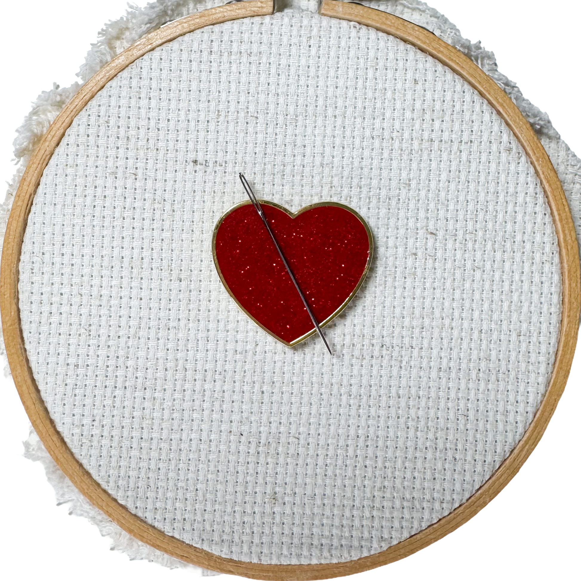 Red glitter heart shaped magnetic enamel needle minder for cross stitch, embroidery, needlepoint and sewing projects.