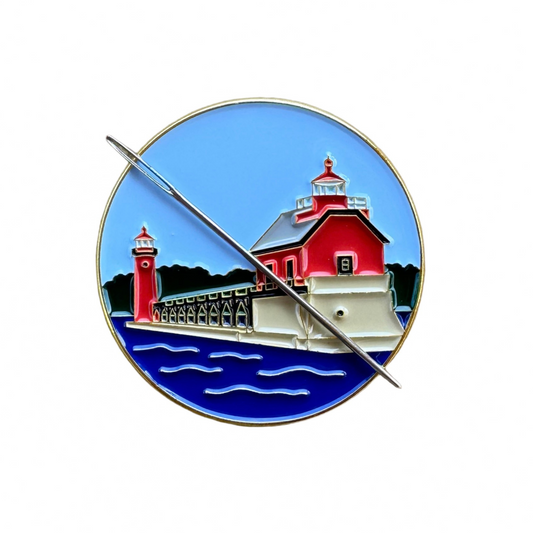 Grand Haven Lighthouse enamel needle minder inspired by the iconic red lighthouses on Lake Michigan, magnetic accessory for cross stitch, needlepoint, embroidery, quilting and sewing.