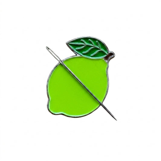 Close up of green lime enamel needle minder with hard enamel finish and metal edging.