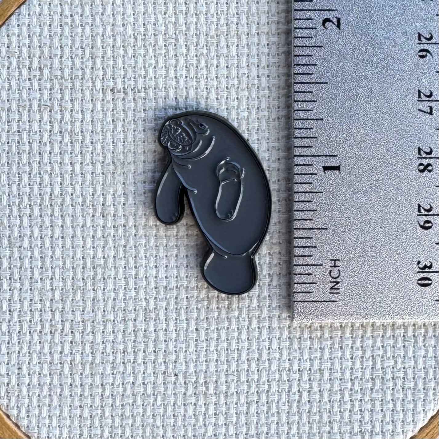 Close-up of manatee magnetic enamel needle minder