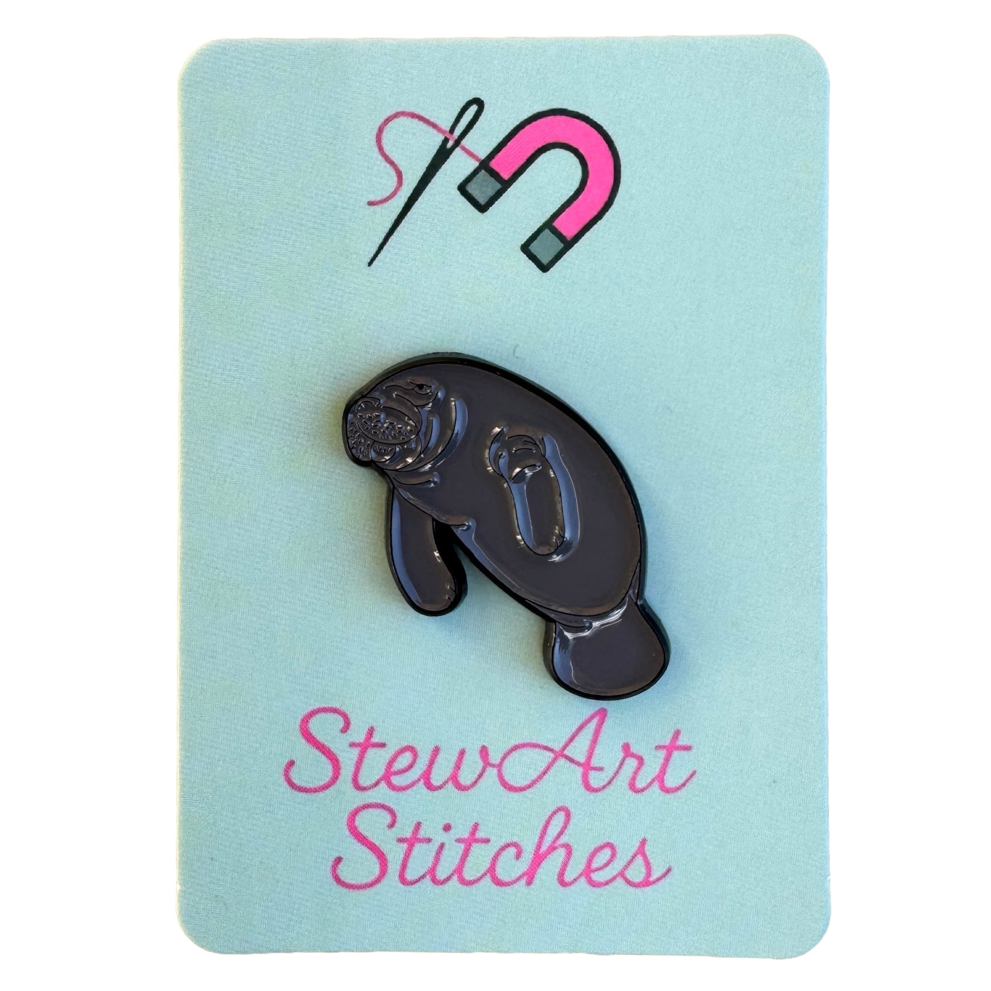 Manatee magnetic enamel needle minder displayed on branded packaging card.
