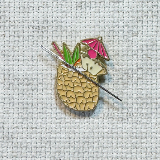 Colorful pineapple colada cocktail enamel needle minder with strong magnet, perfect for holding needles while cross stitching, embroidery, quilting, needlepoint or sewing. Fun drink themed needle holder for stitchers.