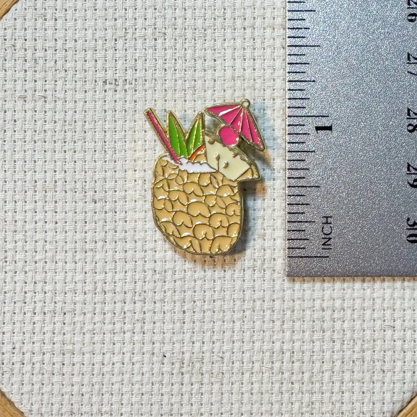 Colorful pineapple colada cocktail enamel needle minder with strong magnet, perfect for holding needles while cross stitching, embroidery, quilting, needlepoint or sewing. Fun drink themed needle holder for stitchers.