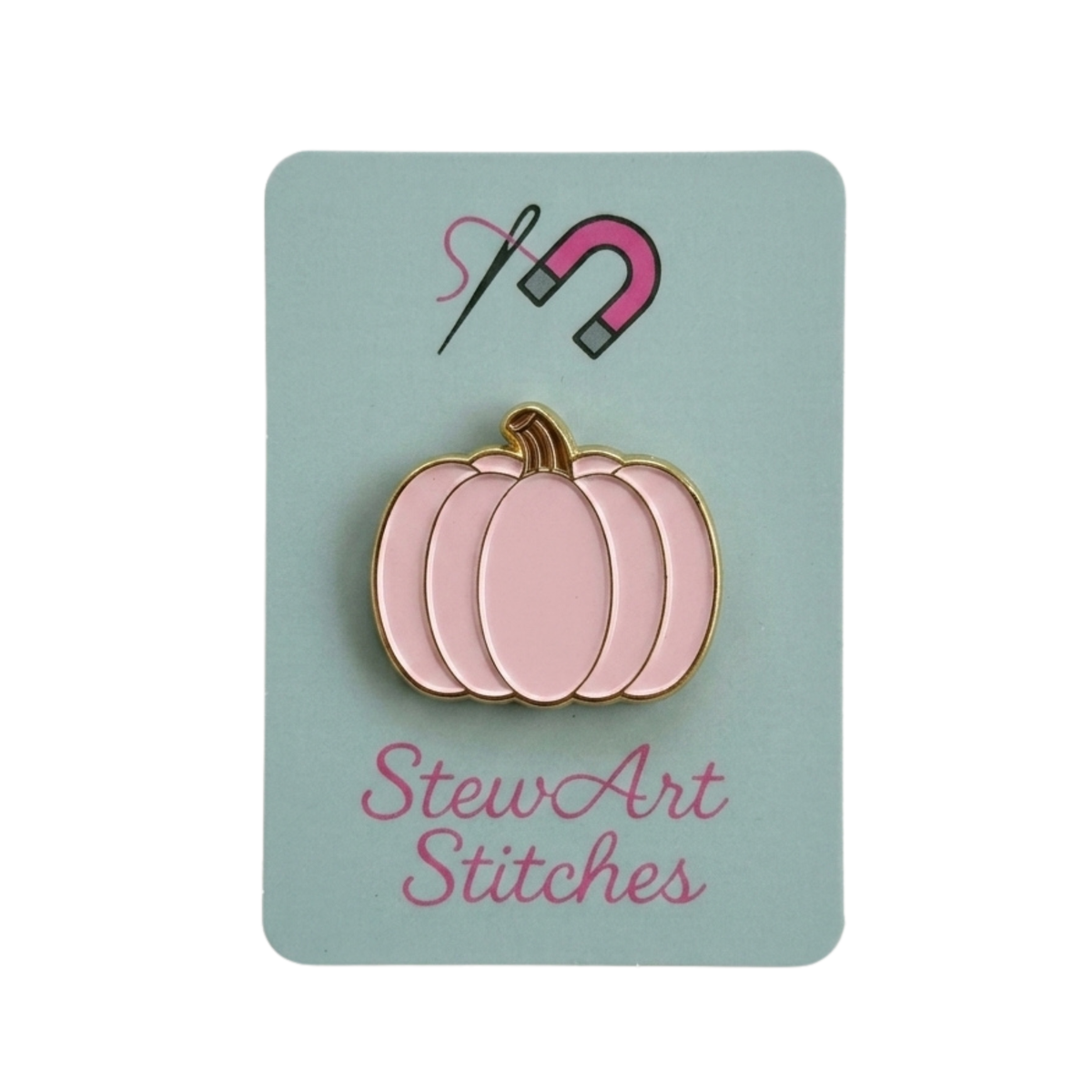 Pink pumpkin magnetic enamel needle minder displayed on product packaging card for StewArt Stitches.