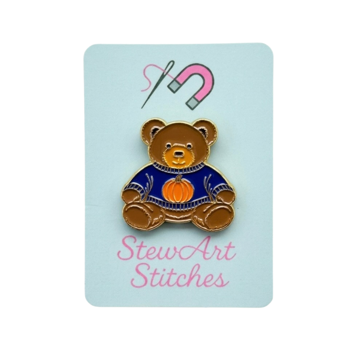 Teddy bear enamel needle minder wearing a blue sweater with a pumpkin, magnetic needle holder for cross stitch, needlepoint, embroidery, quilting, sewing and other stitching projects.