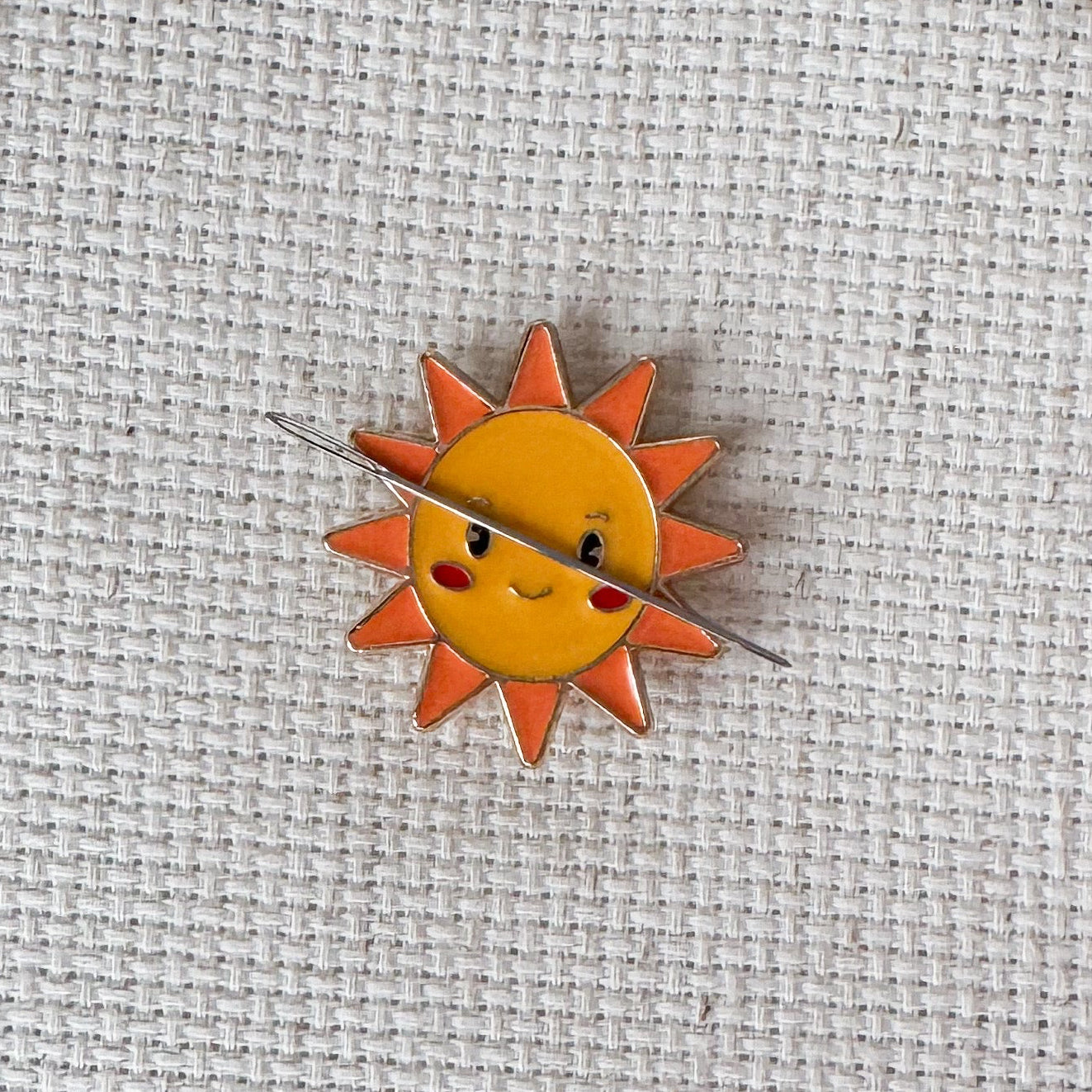 Happy sun face magnetic needle minder – cheerful enamel accessory for cross stitch, embroidery, and needlepoint – cute summer stitching gift for sunshine lovers.