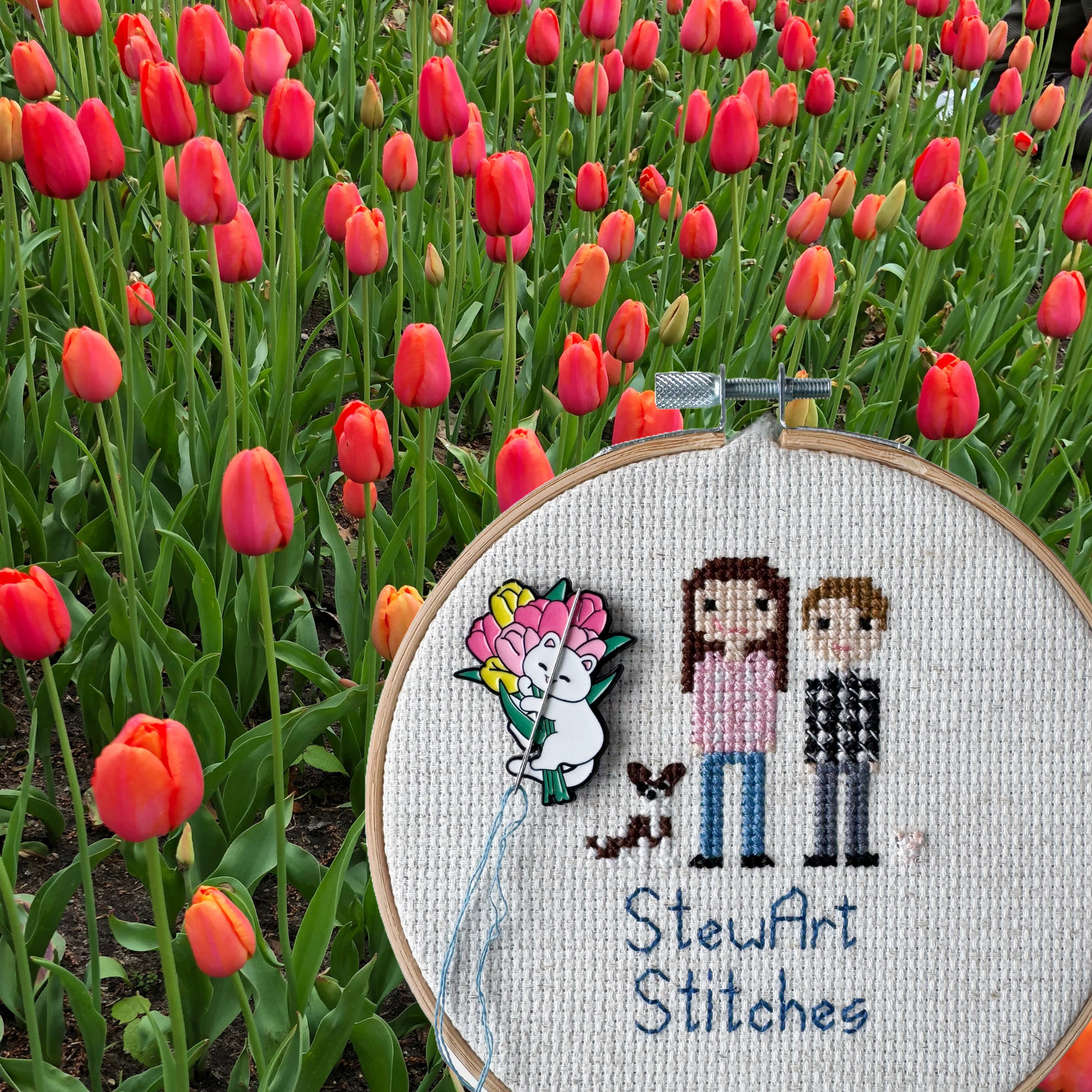 White cat holding pink and yellow tulips needle minder – magnetic enamel holder for cross stitch, embroidery, needlepoint or sewing.